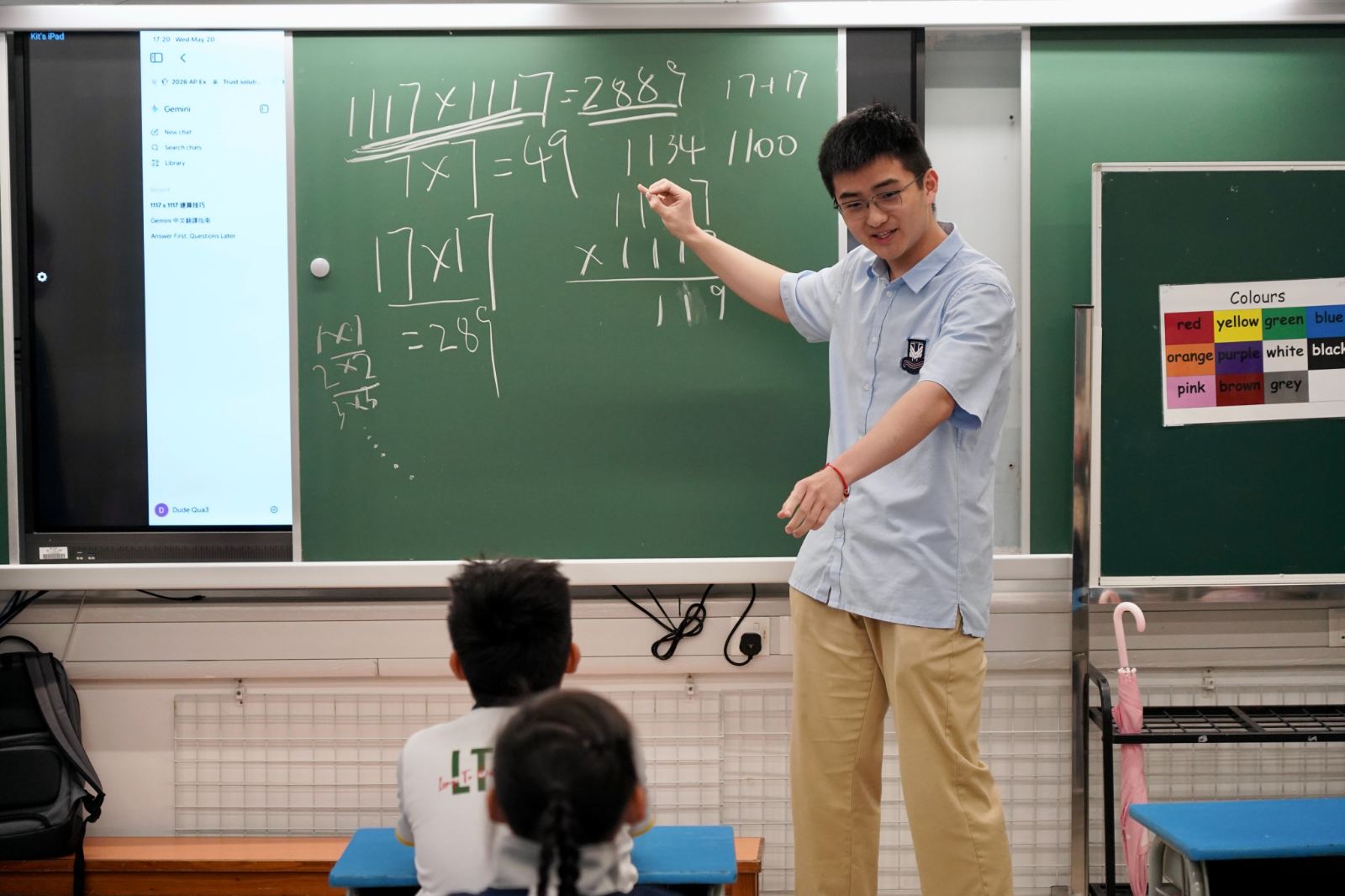 A tutor works through a mental-arithmetic shortcut for 1117 × 1117 on the chalkboard.