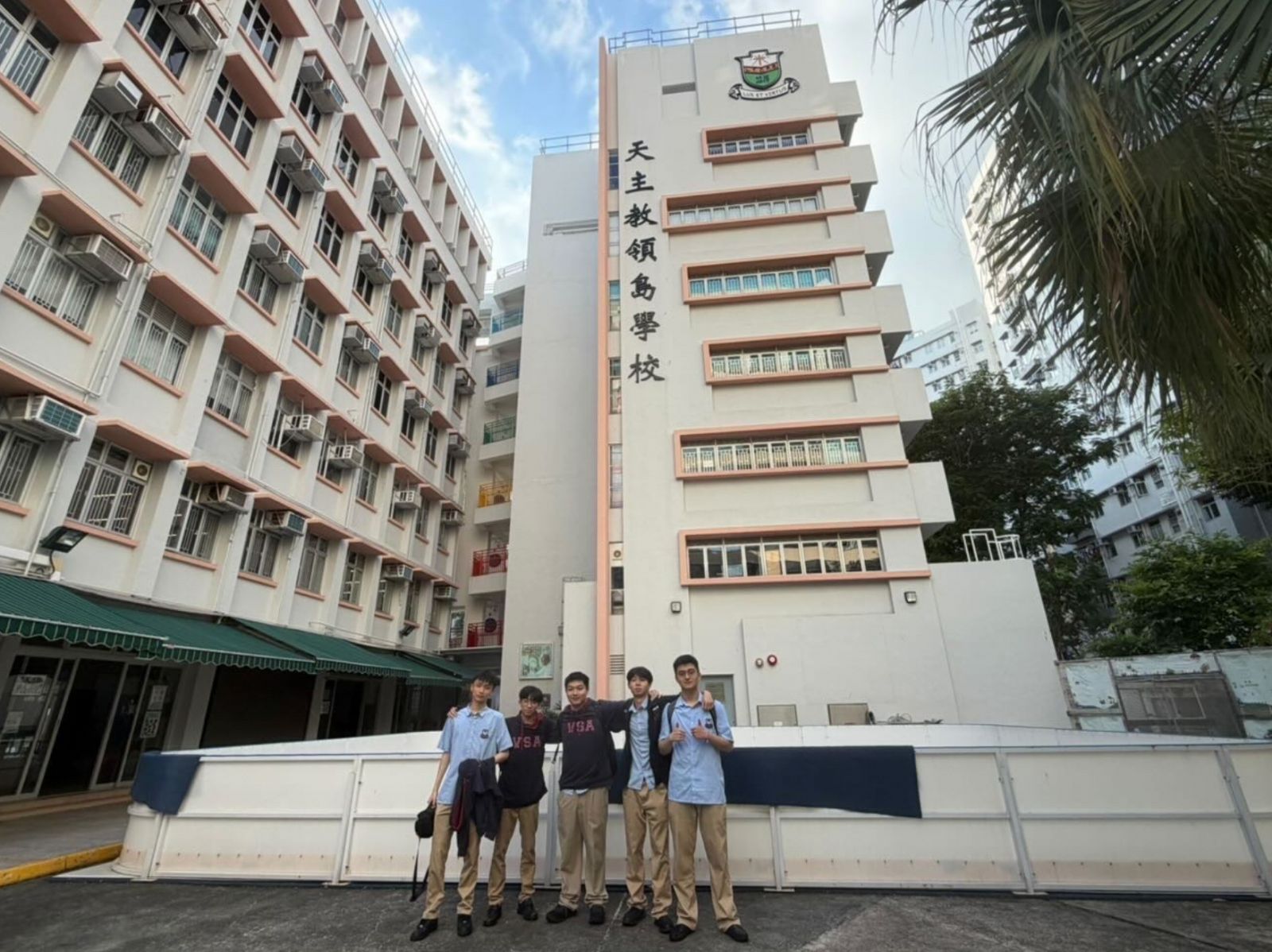 Five AI For Good members outside Ho Man Tin Ling To Catholic School.